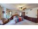 Generously sized bedroom includes bed, furnishings, and ceiling fan at 4915 Millers Trce, Peachtree Corners, GA 30096