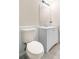 Bathroom features a toilet, vanity, and sink, complemented by a framed mirror at 500 Rosehill Dr, Mcdonough, GA 30253