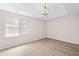Bright bedroom featuring tray ceiling, recessed lighting, and a large window at 500 Rosehill Dr, Mcdonough, GA 30253