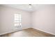 Bedroom with laminate flooring, neutral walls, and natural light from a bright window at 500 Rosehill Dr, Mcdonough, GA 30253