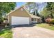 Single story home featuring an attached garage and a partially covered front porch at 500 Rosehill Dr, Mcdonough, GA 30253