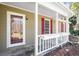 Cozy front porch with red shutters, white railings, and flower boxes at 500 Rosehill Dr, Mcdonough, GA 30253