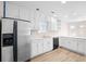 Well-lit kitchen boasts white cabinets and stainless steel refrigerator at 500 Rosehill Dr, Mcdonough, GA 30253