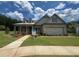 Charming single Gathering home featuring a two-car garage and welcoming covered front porch at 730 Brooke View Drive, Canton, GA 30115