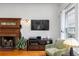 Bright living room features a wooden fireplace, hardwood floors, a comfortable chair and plenty of natural light at 966 Blue Ridge Ne Ave, Atlanta, GA 30306