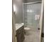 Modern bathroom with a shower over tub and stylish vanity with marble countertops at 970 Tarpley Nw Rd, Kennesaw, GA 30152