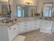 Elegant bathroom featuring dual sinks, a marble countertop, and modern lighting at 970 Tarpley Nw Rd, Kennesaw, GA 30152