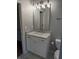 Well lit bathroom featuring a marble countertop vanity with white cabinetry at 970 Tarpley Nw Rd, Kennesaw, GA 30152