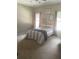 A cozy bedroom with neutral walls, soft carpet, a ceiling fan, and two windows that invite natural light at 970 Tarpley Nw Rd, Kennesaw, GA 30152