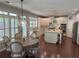 Spacious eat-in kitchen with white cabinets, stainless steel appliances, a center island, and a wooden dining table set at 970 Tarpley Nw Rd, Kennesaw, GA 30152