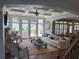 Elegant living room with stone fireplace, built-ins, hardwood floors, coffered ceiling, large windows with backyard views at 970 Tarpley Nw Rd, Kennesaw, GA 30152