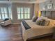 Comfortable main bedroom with a large bed, soft lighting, and views of the backyard at 970 Tarpley Nw Rd, Kennesaw, GA 30152
