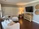 Comfortable sitting area with hardwood floors, white walls, stylish decor, and a large media console at 970 Tarpley Nw Rd, Kennesaw, GA 30152