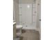 Clean and modern bathroom shower space, featuring a crisp white design with built-in shelving and neutral tile flooring at 2424 Saint Andrews Rdg, College Park, GA 30337