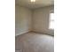 Inviting bedroom featuring neutral carpet, soft lighting, and a window for a serene atmosphere at 2424 Saint Andrews Rdg, College Park, GA 30337