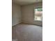 Cozy bedroom with neutral carpet, freshly painted walls, and a window for natural light at 2424 Saint Andrews Rdg, College Park, GA 30337