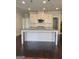 Bright kitchen with white cabinets, granite countertops, and a large center island for cooking and entertaining at 2424 Saint Andrews Rdg, College Park, GA 30337