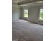 Spacious bedroom with plush carpet, neutral colors, and two large windows, creating a relaxing retreat at 2424 Saint Andrews Rdg, College Park, GA 30337