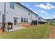 Townhome backyard featuring a patio area, lush green grass, and wood-look fence at 3560 Bexton Dr, Duluth, GA 30097