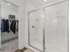 Bathroom with glass-enclosed shower and adjacent walk-in closet at 3560 Bexton Dr, Duluth, GA 30097