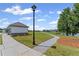 Well-maintained community with walking path, pond, and greenspace on a sunny day with blue skies and light clouds at 3560 Bexton Dr, Duluth, GA 30097