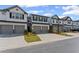 Exterior shot of well-maintained townhomes with driveways at 3560 Bexton Dr, Duluth, GA 30097
