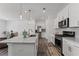 New kitchen features white cabinets, stainless appliances, and a functional center island with granite counter at 3560 Bexton Dr, Duluth, GA 30097