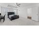 Bright main bedroom featuring tray ceiling, plush carpeting, and a large bed at 3560 Bexton Dr, Duluth, GA 30097