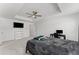 Spacious main bedroom featuring tray ceiling, plush carpeting, and a tv at 3560 Bexton Dr, Duluth, GA 30097