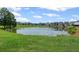 Calming pond with beautiful homes in the background, showcasing a serene community setting at 3560 Bexton Dr, Duluth, GA 30097