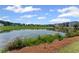 Picturesque pond surrounded by lush greenery with beautiful homes in the background on a sunny day at 3560 Bexton Dr, Duluth, GA 30097