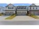 Charming townhomes showcasing well-manicured landscaping and attached garages at 3560 Bexton Dr, Duluth, GA 30097