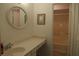 Bright bathroom with a round mirror and a vanity with drawers and cabinets at 1932 Variations Ne Dr, Atlanta, GA 30329