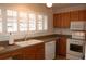 Bright kitchen with a double sink, white appliances, and wooden cabinets at 1932 Variations Ne Dr, Atlanta, GA 30329