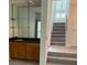 Open living room with a bar, staircase, and hardwood flooring at 1932 Variations Ne Dr, Atlanta, GA 30329