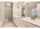 Bright bathroom featuring double sink vanity, tile flooring, and large mirrors at 230 Belmont Trl, Covington, GA 30016