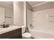 Bathroom featuring a tub and shower combination, dark wood vanity and neutral paint at 230 Belmont Trl, Covington, GA 30016