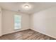 Bedroom showing light walls, wood floors and a window for natural light at 230 Belmont Trl, Covington, GA 30016