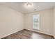 This bedroom has wood floors, a window, and neutral walls and trim at 230 Belmont Trl, Covington, GA 30016