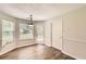 Well-lit dining area with stylish light fixture, windows, and access to the backyard at 230 Belmont Trl, Covington, GA 30016