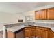 Stylish kitchen with granite countertops offering views into the bright and airy living room at 230 Belmont Trl, Covington, GA 30016