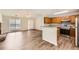 Open-concept living space with a fireplace flowing into a kitchen with granite countertops and wood cabinets at 230 Belmont Trl, Covington, GA 30016