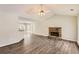 Open-concept living room with vaulted ceilings, modern flooring, and a charming stone fireplace at 230 Belmont Trl, Covington, GA 30016