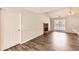 Inviting living room featuring a brick fireplace, vaulted ceiling, and wood-look flooring at 230 Belmont Trl, Covington, GA 30016