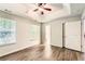 Bright main bedroom featuring a tray ceiling, ceiling fan, and ensuite bathroom access at 230 Belmont Trl, Covington, GA 30016