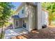 View of the back of the house, showing the siding and patio area with lush, mature landscaping at 2346 Hampton Park Dr, Buford, GA 30519