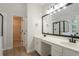 Modern bathroom featuring dual sinks, a large mirror, and a glass-enclosed shower at 2346 Hampton Park Dr, Buford, GA 30519