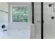 Bright bathroom showcasing a separate shower and tub with dark hardware, along with a window that provides natural light at 2346 Hampton Park Dr, Buford, GA 30519