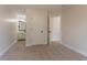View of a bedroom with an adjacent bathroom and closet space, carpeted floors and neutral walls at 2346 Hampton Park Dr, Buford, GA 30519