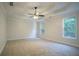Spacious bedroom with a tray ceiling, ceiling fan, two windows offering plenty of natural light at 2346 Hampton Park Dr, Buford, GA 30519